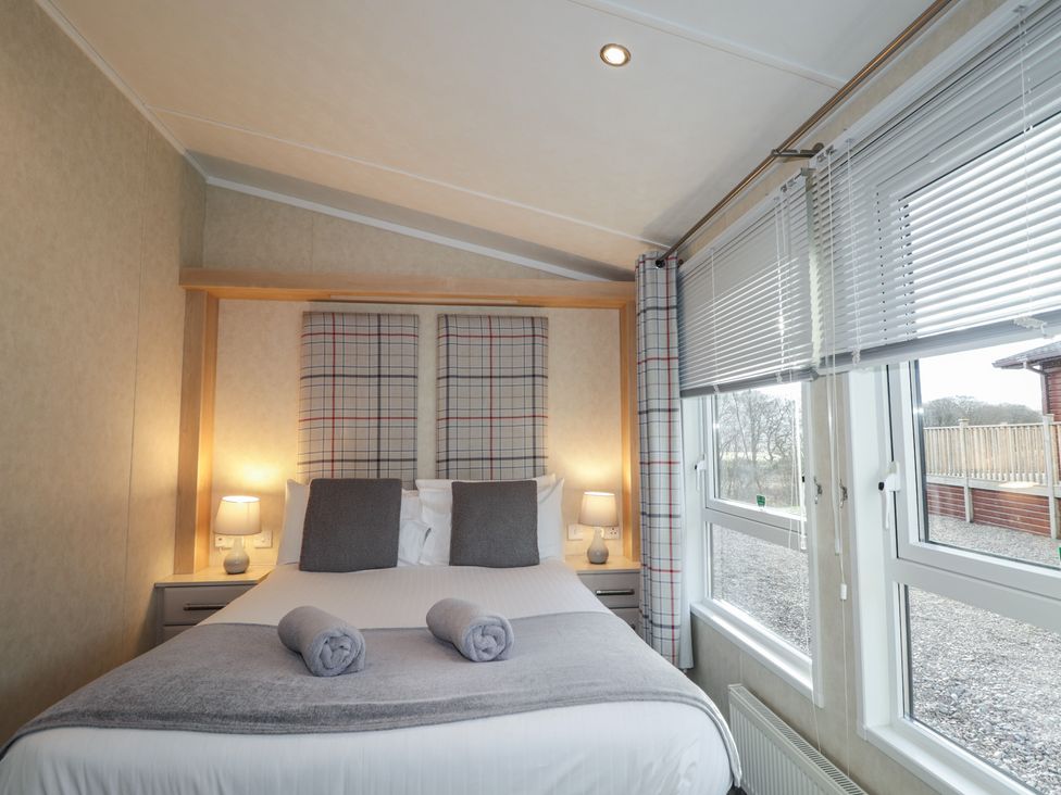 A bedroom with a bed and lamps at Monach 2 in Fort William