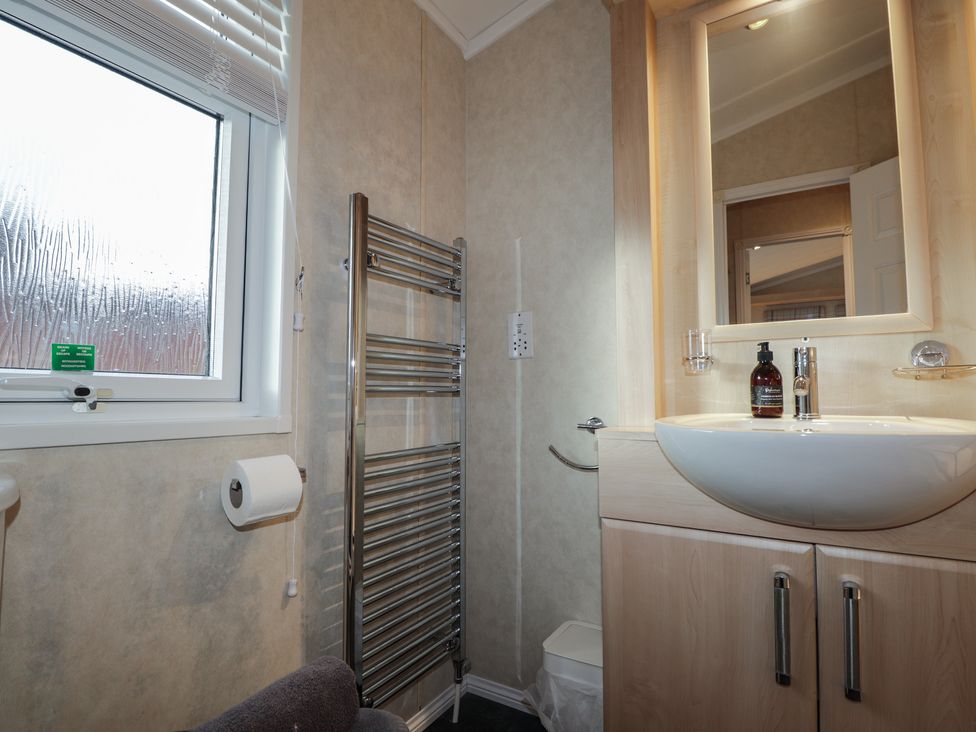 A bathroom with a wash basin and towel rail at Monach 2 Fort William