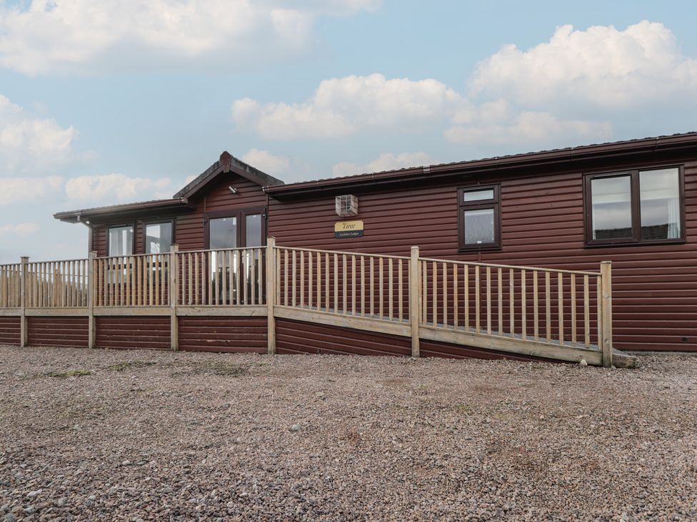 A wooden lodge with a ramp and deck at Monach 3 in Fort William