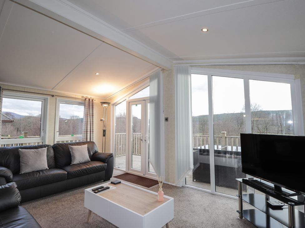 A living room with a sofa and television at Monach 3 Fort William