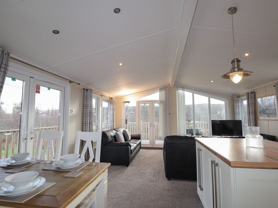 A living room with a sofa and table at Monach 3 in Fort William