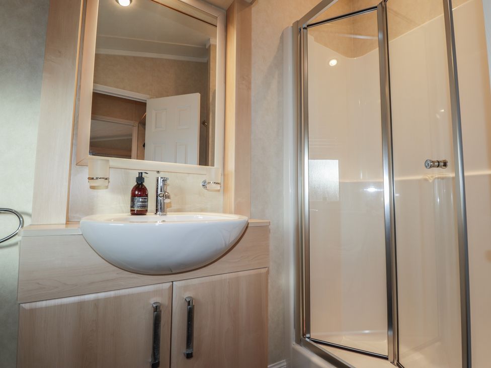 A bathroom with a wash basin and shower stall at Monach 3 in Fort William