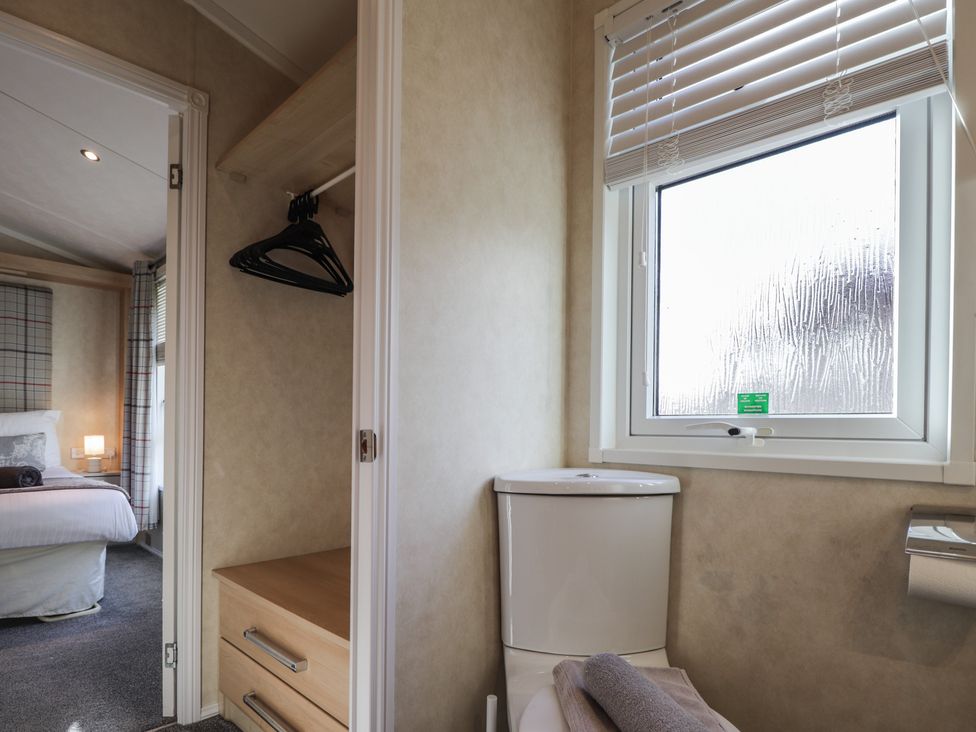 A bathroom with a toilet and window at Monach 3, Fort William