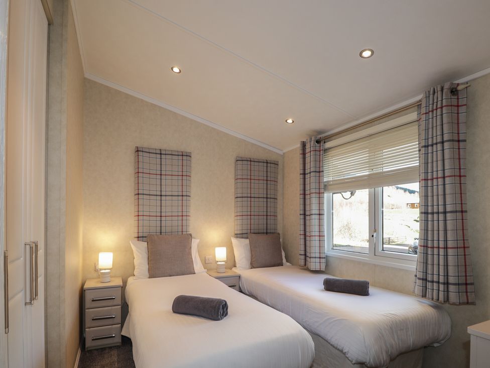 A bedroom with two beds and a window at Monach 3 Fort William