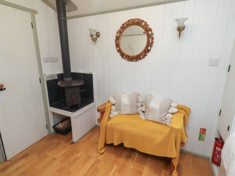 A living room with a stove and couch at Woodland in Hexham