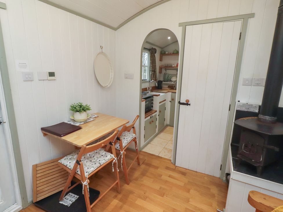 A kitchen with a table and chairs at Woodland in Hexham