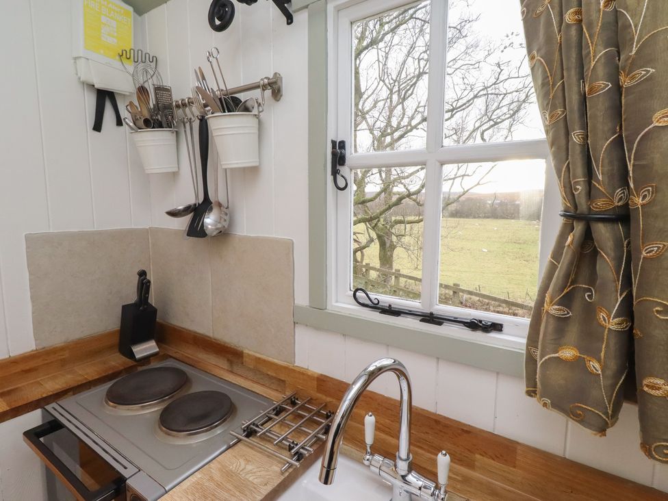 A kitchen with a sink and stove at Woodland in Hexham