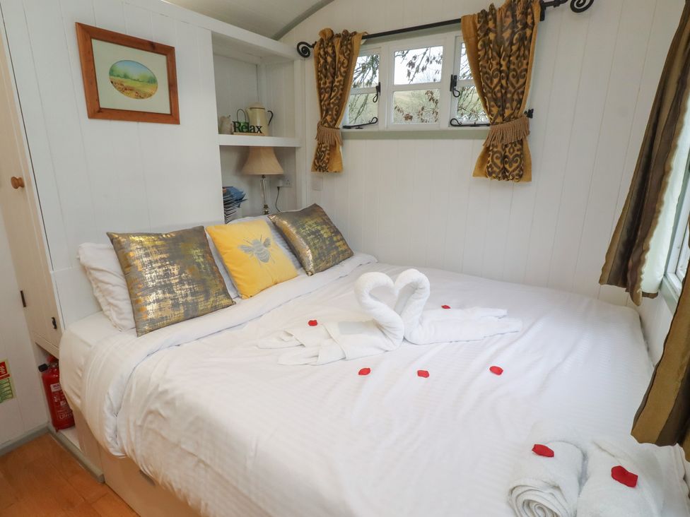 A bedroom with a bed and decorative pillows at Woodland in Hexham