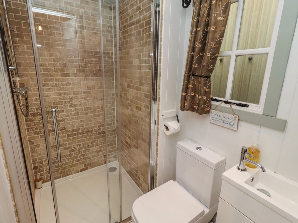 A bathroom with a shower and toilet at Woodland in Hexham