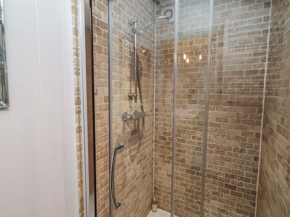 A shower with glass walls at Woodland in Hexham