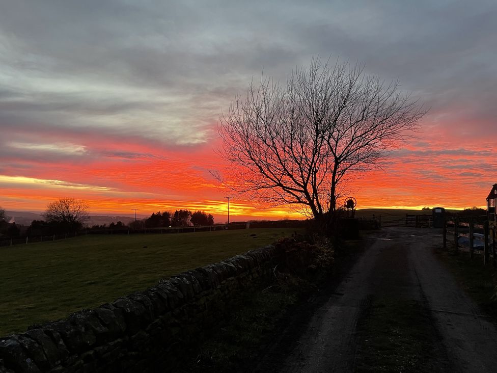 A sunset view with a tree and a road at The Farmhouse in High Peak