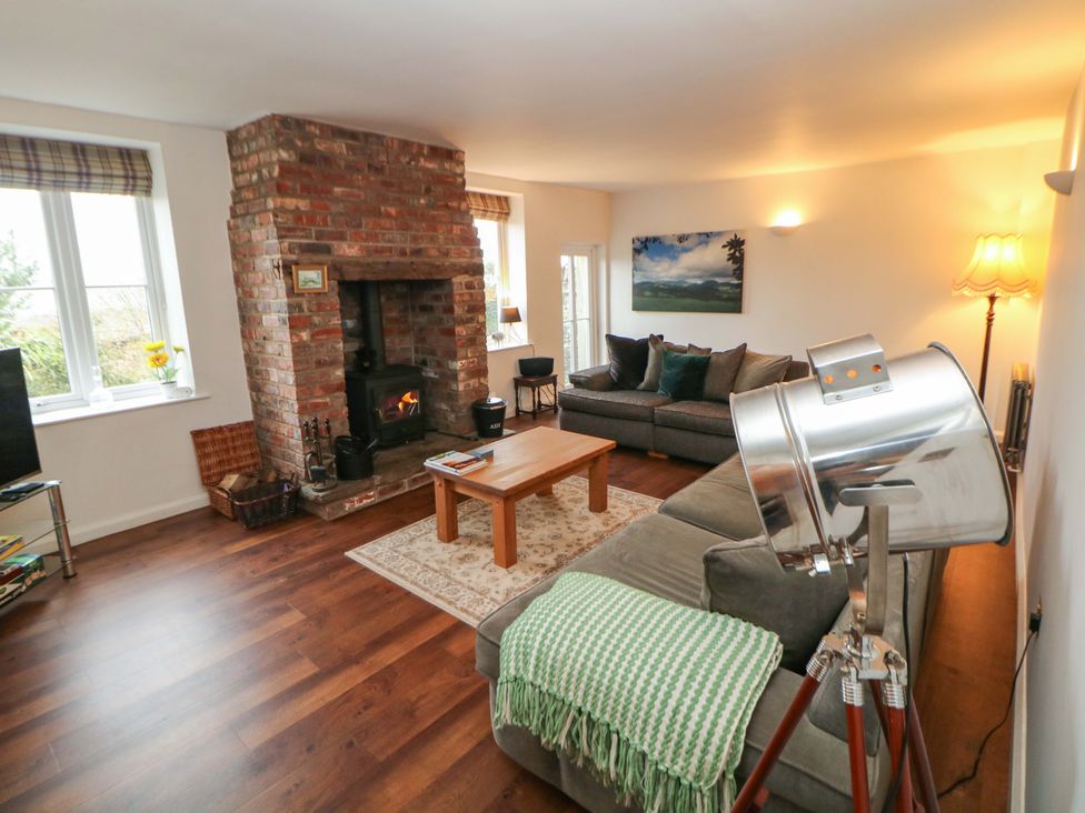 A living room with a sofa and coffee table at The Farmhouse in High Peak