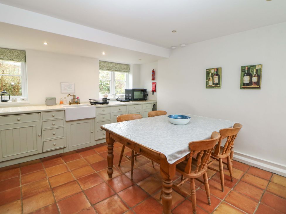 A kitchen with a dining table and chairs at The Farmhouse High Peak