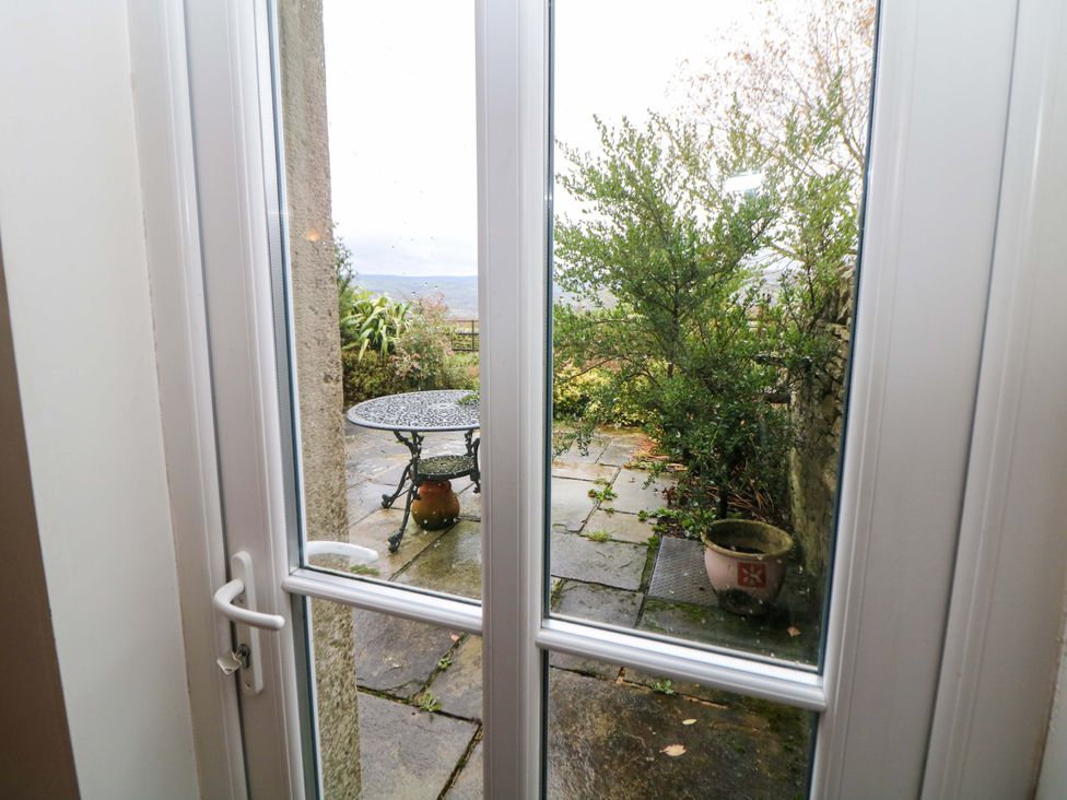 A garden view with a table and potted plant at The Farmhouse in High Peak