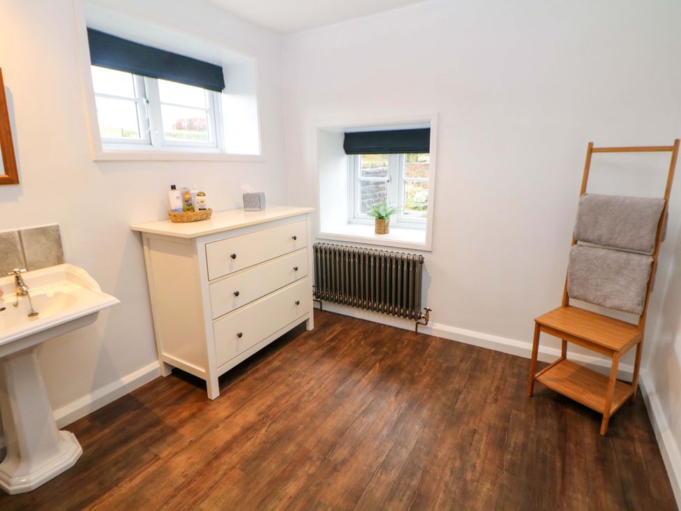 A bathroom with a sink and dresser at The Farmhouse in High Peak