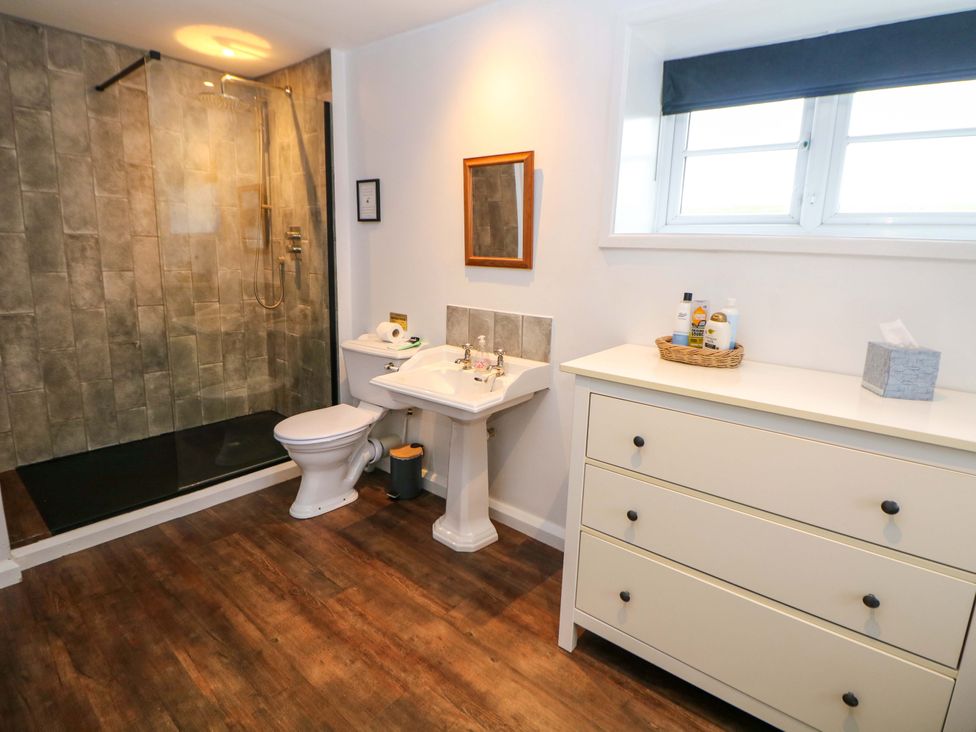 A bathroom with shower, toilet, sink, and drawer at The Farmhouse in High Peak