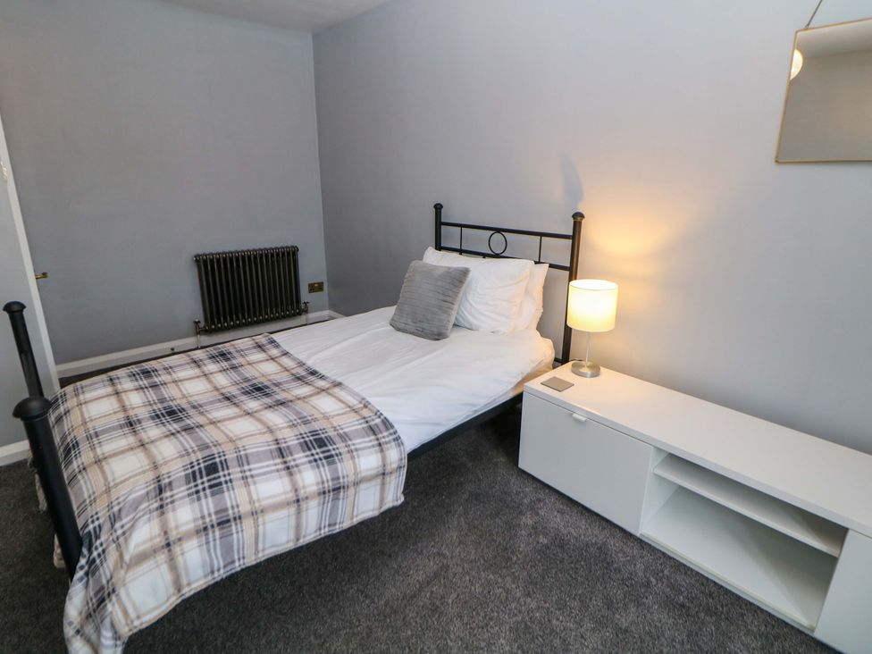 A bedroom with a bed and lamp at The Farmhouse in High Peak
