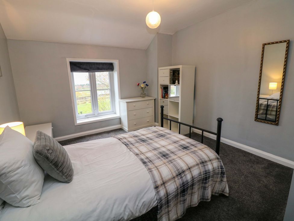 A bedroom with a bed and dresser at The Farmhouse in High Peak