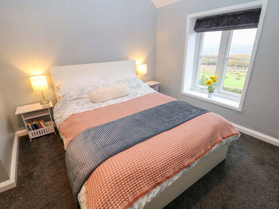 A bedroom with a bed and a window at The Farmhouse High Peak