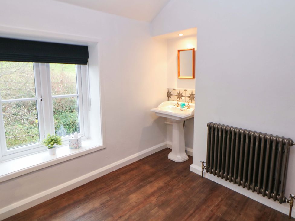 A bathroom with a sink and mirror at The Farmhouse High Peak