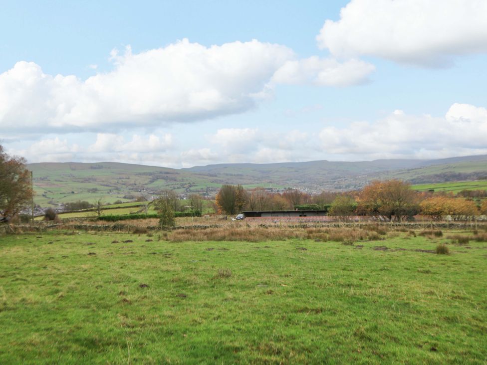 A landscape with grass and trees at The Farmhouse in High Peak