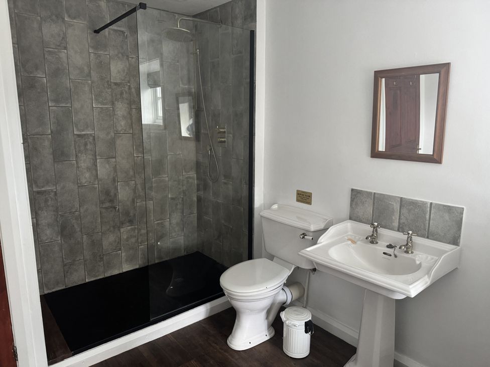 A bathroom with a shower, toilet, and sink at The Farmhouse in High Peak