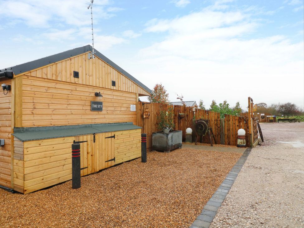 A wooden building with a sign at The Sty in Derby