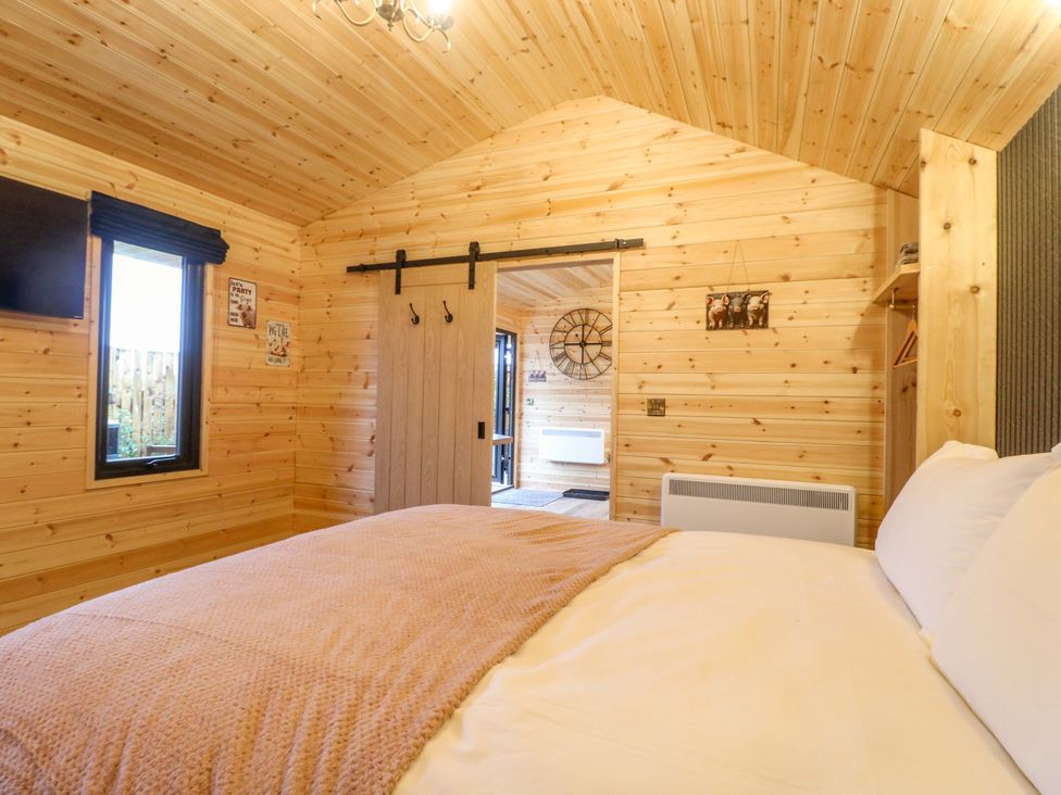 A bedroom with a bed and television at The Sty in Derby