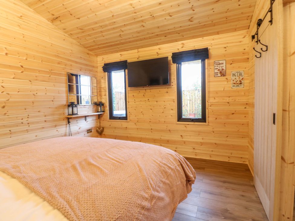 A bedroom with a bed and television at The Sty in Derby