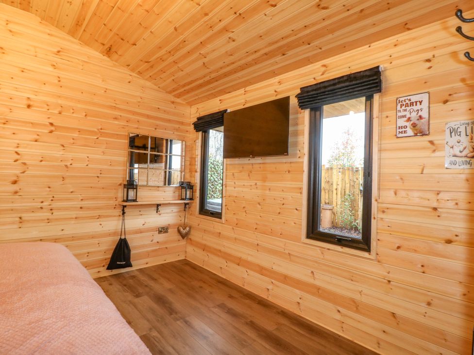 A snug with wooden walls and a television at The Sty in Derby