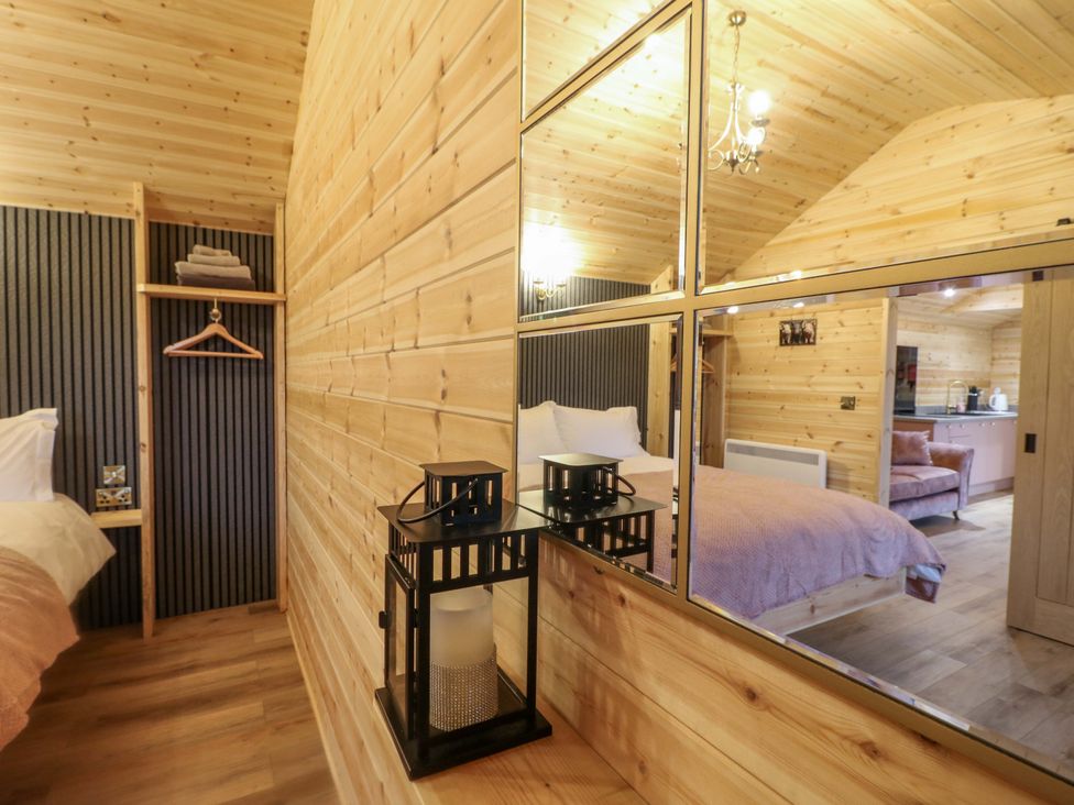 A bedroom with a bed and mirror at The Sty in Derby