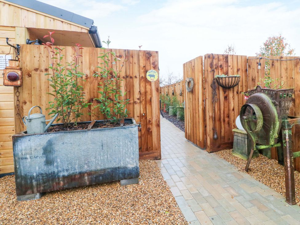 A garden with a pathway and planters at The Sty in Derby