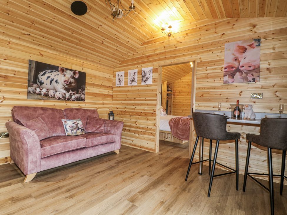 A snug with a sofa and bar stools at The Sty in Hatton, Derbyshire