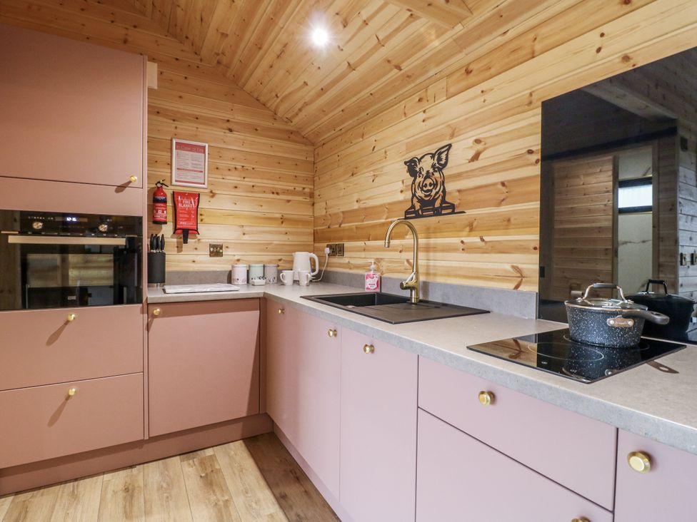 A kitchen with cabinets and sink at The Sty in Hatton, Derbyshire