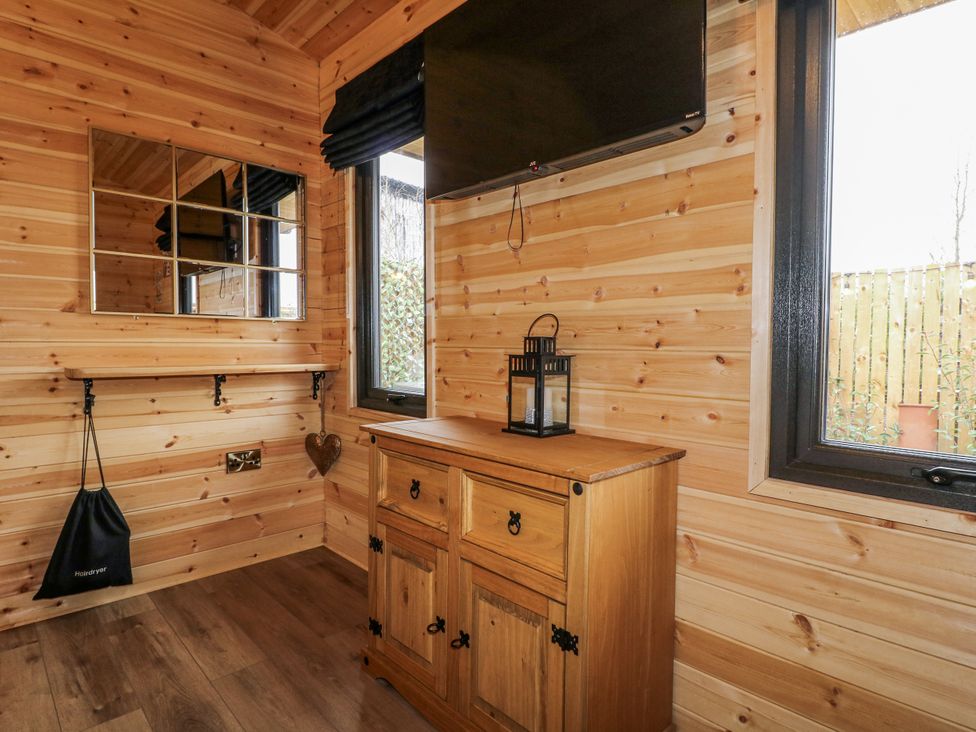 A room with a television and a wooden chest at The Sty in Hatton, Derbyshire