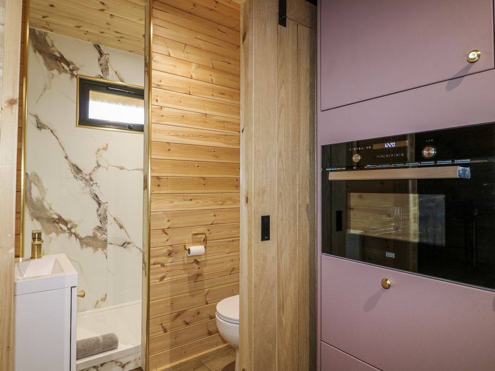 A bathroom with a sink and toilet at The Sty in Hatton, Derbyshire