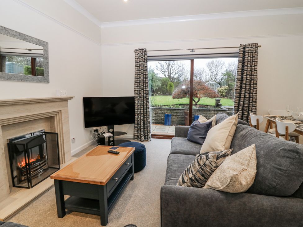 A living room with a sofa and television at Cairndhu in Bossiney