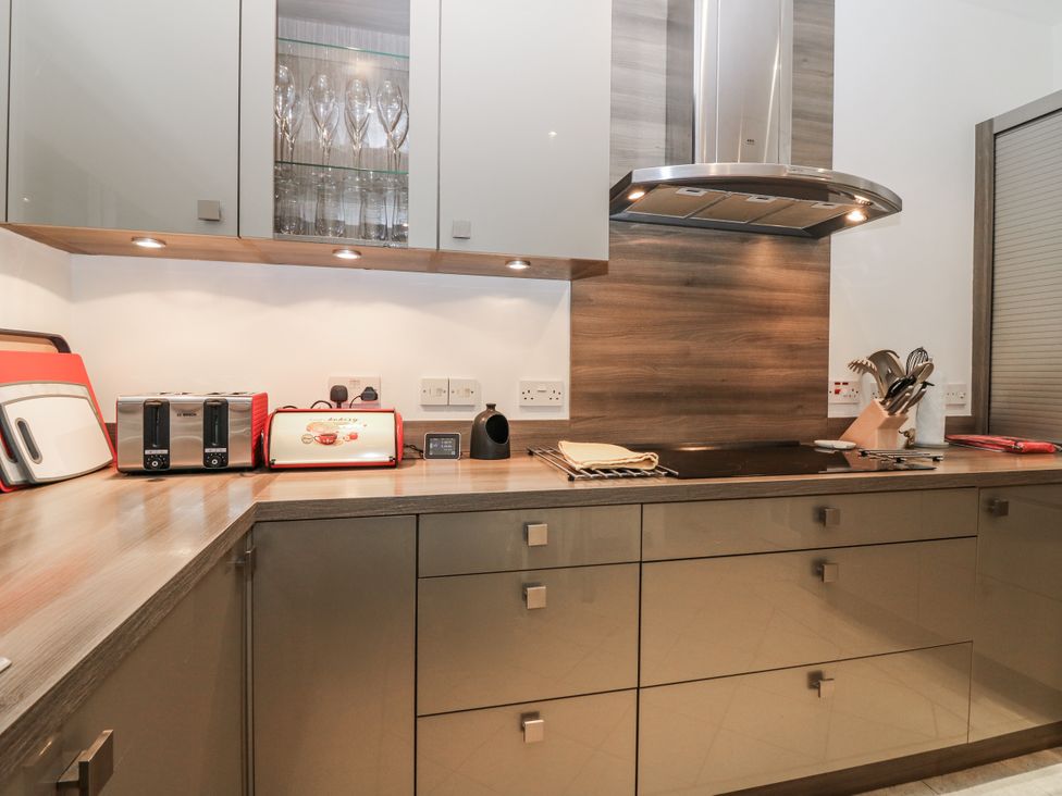A kitchen with appliances and cabinets at Cairndhu in Bossiney