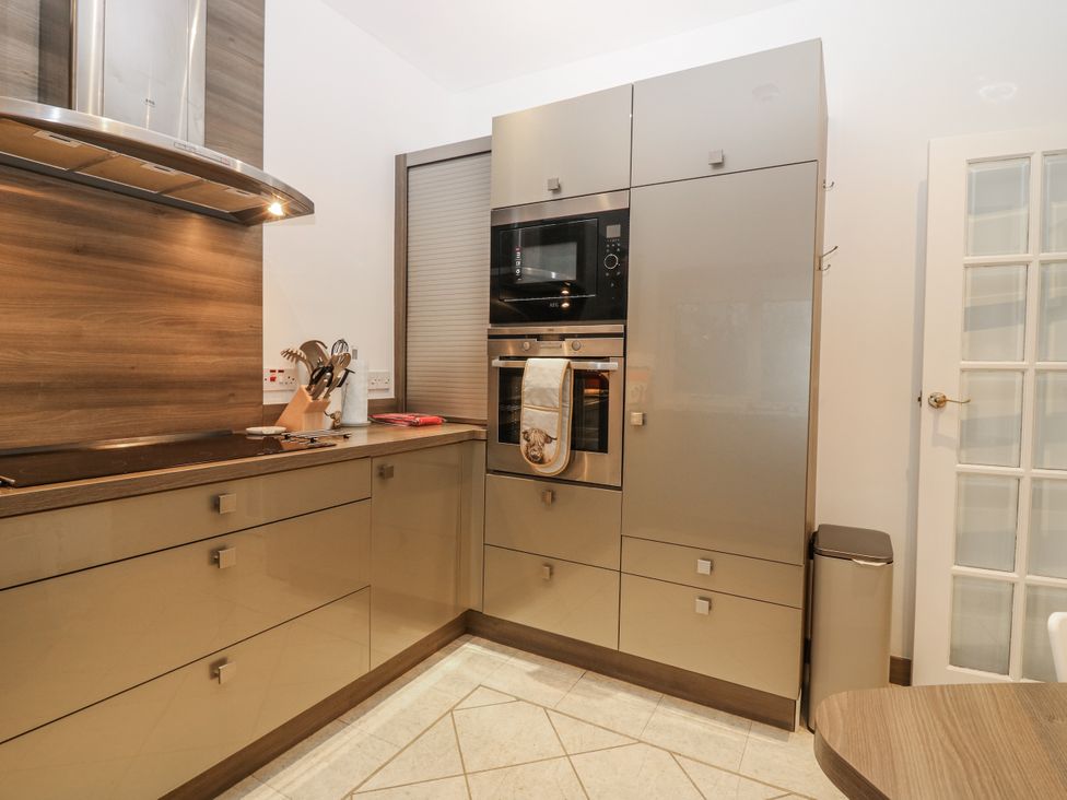 A kitchen with cabinets and oven at Cairndhu in Bossiney