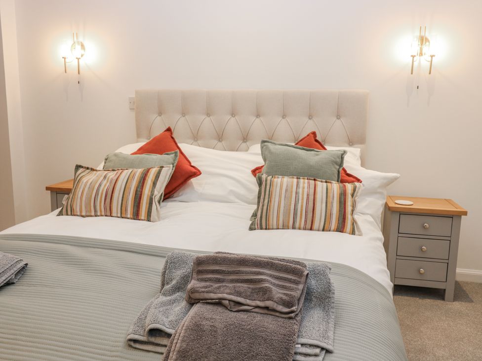 A bedroom with a bed and pillows at Cairndhu in Bossiney