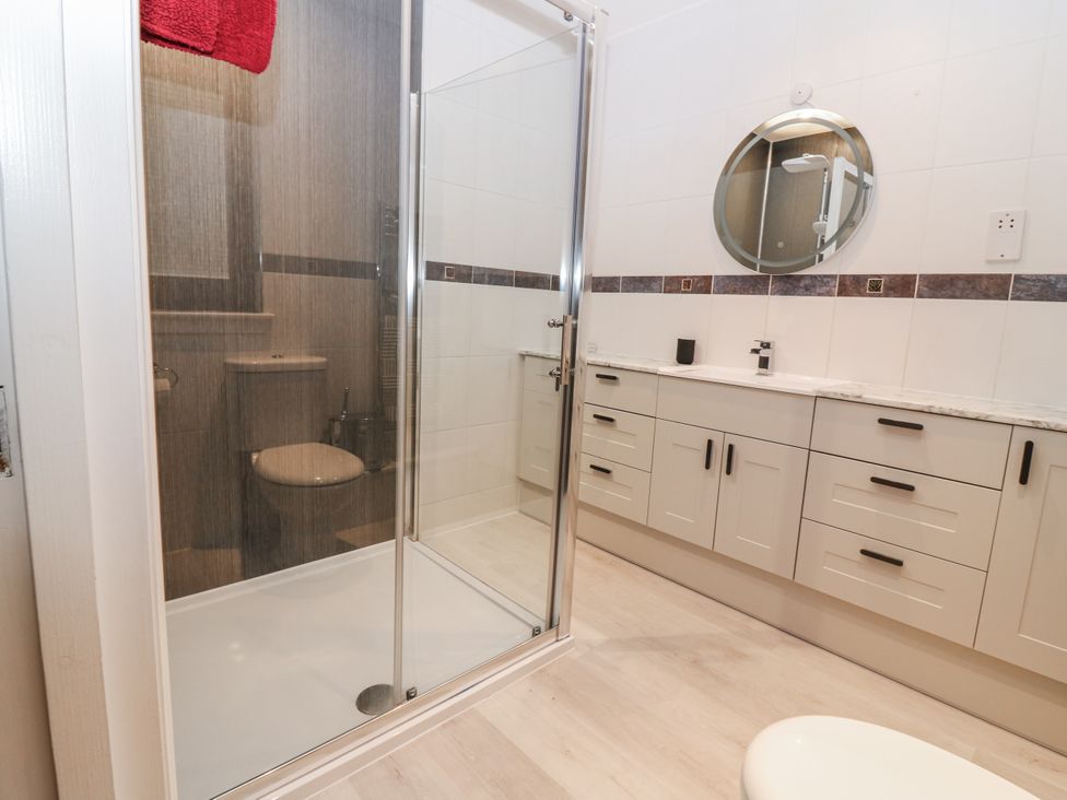 A bathroom with a shower and sink at Cairndhu in Bossiney