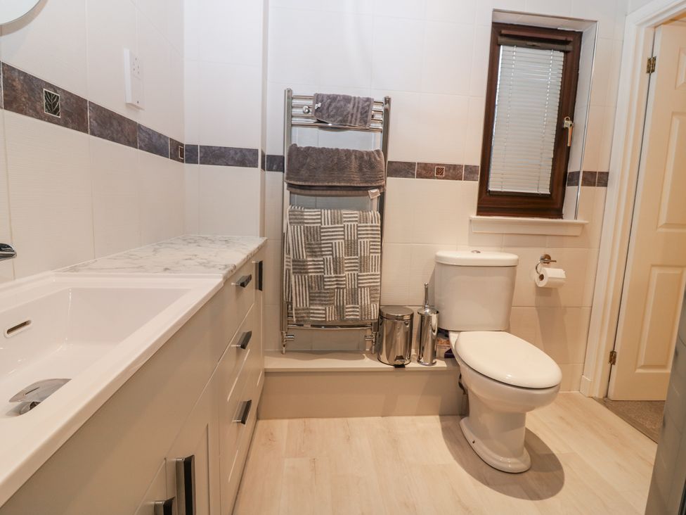 A bathroom with a sink and toilet at Cairndhu in Bossiney