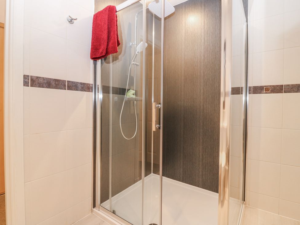 A shower with a towel hanging in the bathroom at Cairndhu in Bossiney