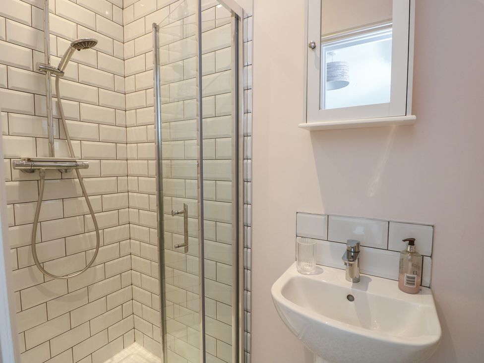 A bathroom with a shower and sink at Bryn Y Mor Beaumaris