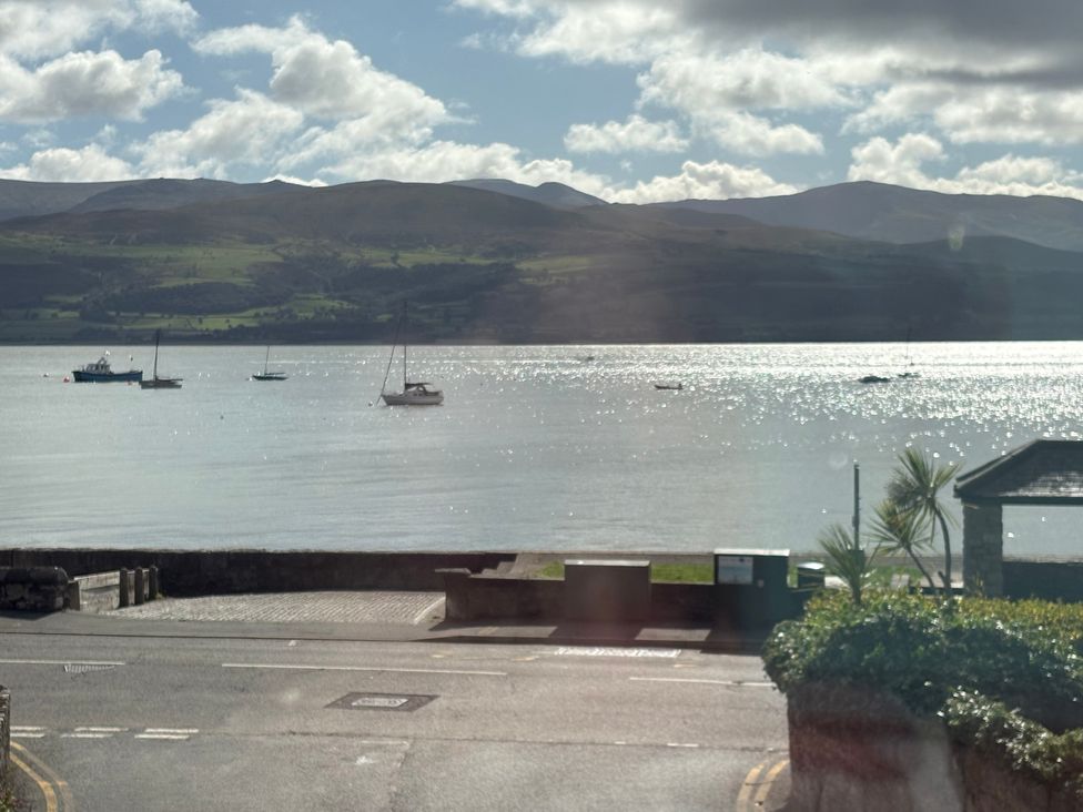 A view of boats on water with mountains in the background at Bryn Y Mor Beaumaris