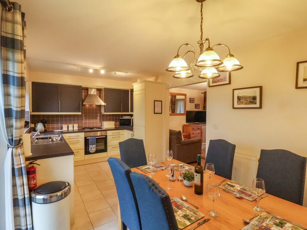 A kitchen with a dining area at Bumblebee Cottage in Whitby