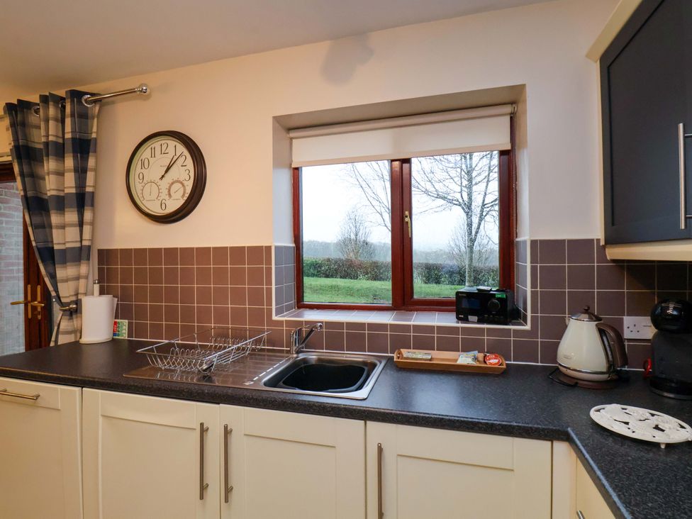 A kitchen with a window and sink at Bumblebee Cottage in Whitby