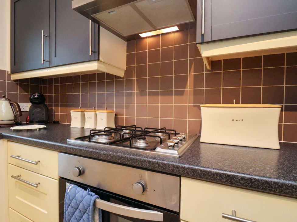 A kitchen with a gas hob and various appliances at Bumblebee Cottage in Whitby