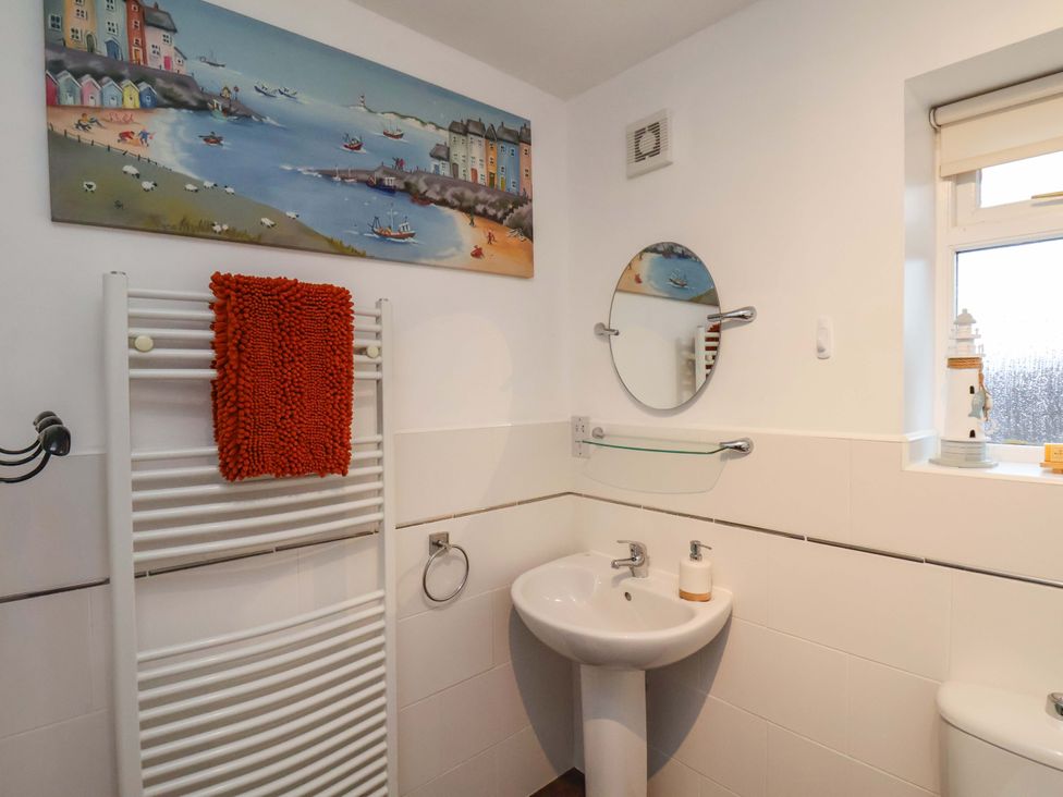 A bathroom with a sink and towel radiator at Bumblebee Cottage in Whitby