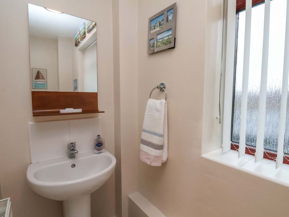 A bathroom with a sink and towel holder at Bumblebee Cottage in Whitby